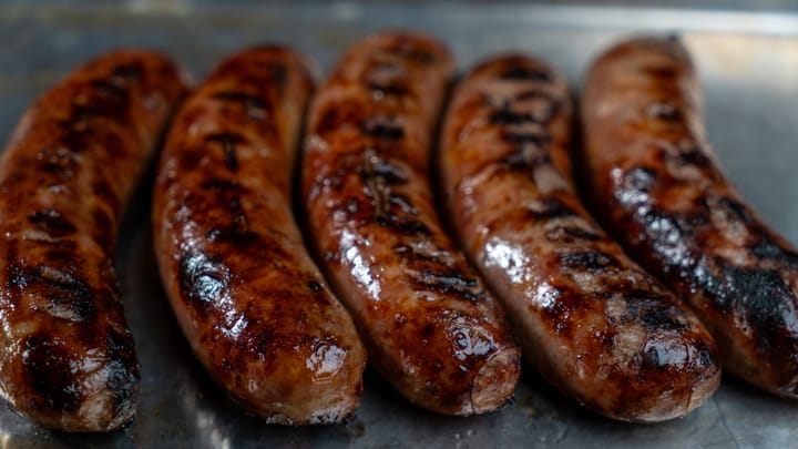 Beer Braised and Grilled Brats with Onions